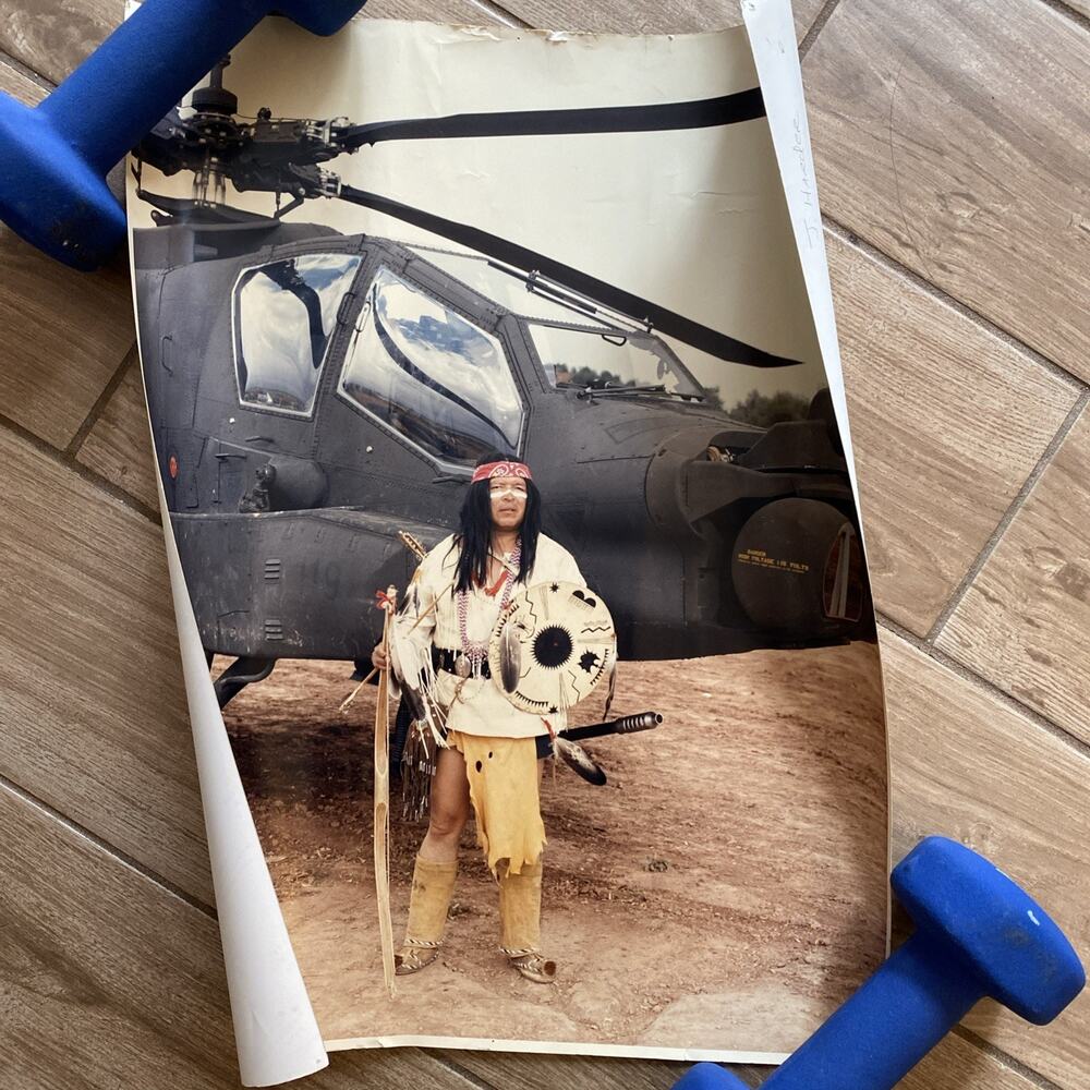 White Mountain Apache Indian poses in front of first production AH-64A 1984
